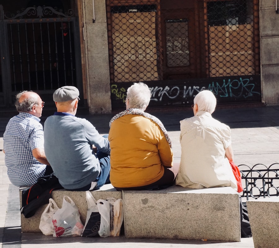 Several people sitting together on a bench outdoors